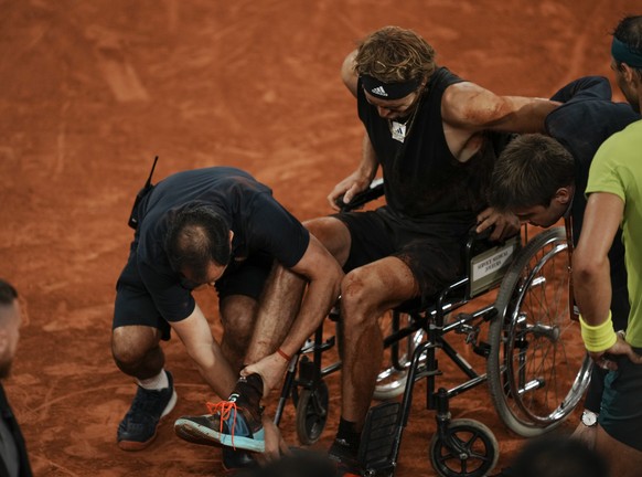 Germany&#039;s Alexander Zverev is carried into a wheelchair after twisting his ankle in the semifinal match against Spain&#039;s Rafael Nadal, right and watching, at the French Open tennis tournament ...