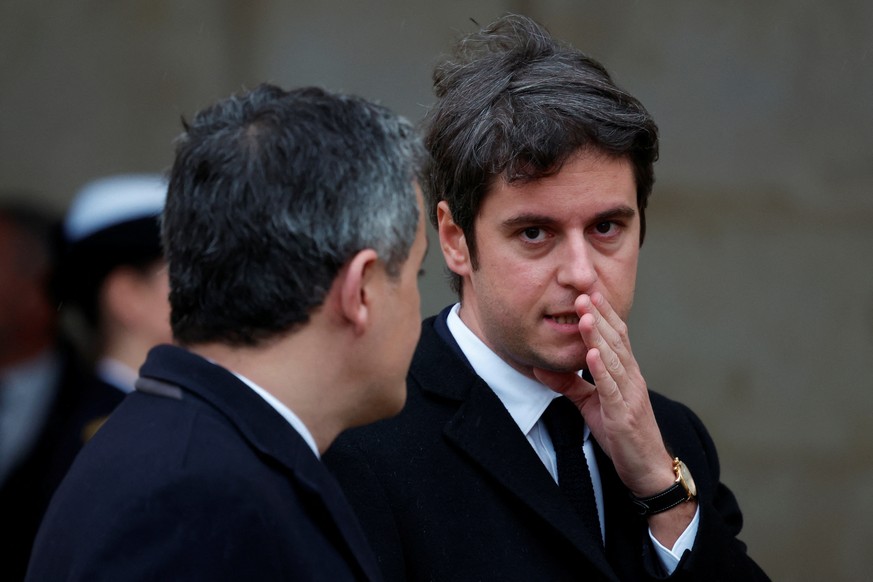 epa11133528 (L-R) French Interior Minister Gerald Darmanin and Prime Minister Gabriel Attal arrive to attend a ceremony to pay tribute to the 42 French citizens killed and to all the victims of the 07 ...