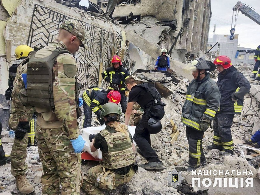 epa10715622 A handout photo made available by the National Police of Ukraine shows rescuers at work at the site of a rocket strike in downtown Kramatorsk, Donetsk area, Ukraine, 28 June 2023, amid the ...