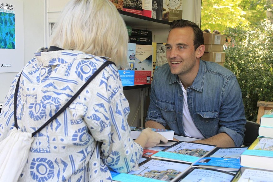epa06008041 Swiss writer Joel Dicker signs copies of his book 'The Truth About the Harry Querbert Affair' during the 76th edition of Madrid's Book Fair at El Retiro Park in downtown Mad ...