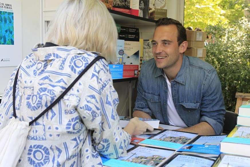 epa06008041 Swiss writer Joel Dicker signs copies of his book &#039;The Truth About the Harry Querbert Affair&#039; during the 76th edition of Madrid&#039;s Book Fair at El Retiro Park in downtown Mad ...