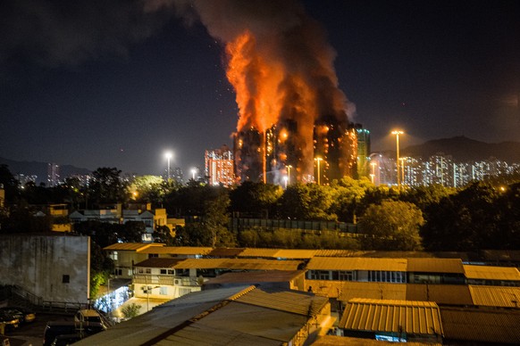 epa12549748 An apartment burns in Tai Po in Hong Kong, China, 26 November 2025. According to the Hong Kong government, the five alarm fire, which started 26 November, has left four people dead and thr ...