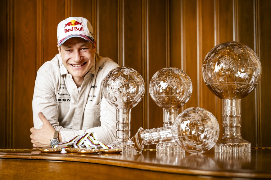 Marco Odermatt of Switzerland poses with men&#039;s World Cup overall crystal globe trophy, the men&#039;s Downhill discipline leader crystal globe trophy, the men&#039;s Super-g discipline leader cry ...