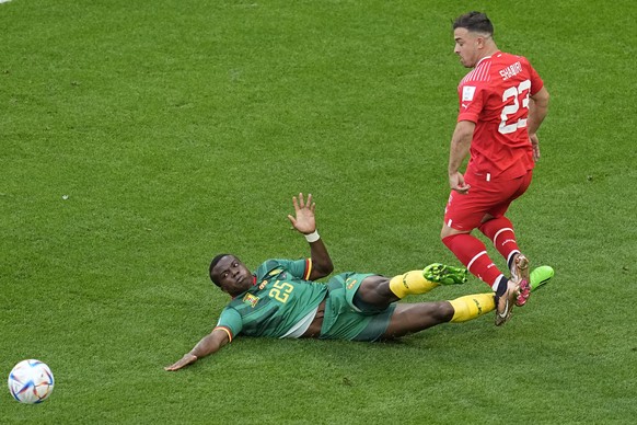 Switzerland's Xherdan Shaqiri is tackled by Cameroon's Tolo Nouhou during the World Cup group G soccer match between Switzerland and Cameroon, at the Al Janoub Stadium in Al Wakrah, Qatar, Thursday, N ...