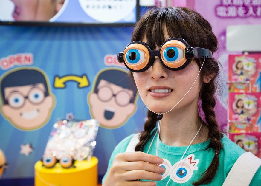 epa05352512 A campaign model demonstrates crazy eyes glasses during the International Tokyo Toy Show 2016 in Tokyo, Japan, 09 June 2016. The trade show opens to the general public on 11 and 12 June. E ...