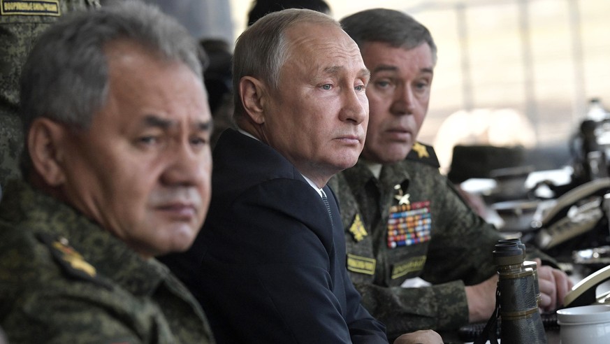 FILE - Russian President Vladimir Putin, center, Russian Defense Minister Sergei Shoigu, left, and Head of the General Staff of the Armed Forces of Russia and First Deputy Defense Minister Valery Gera ...