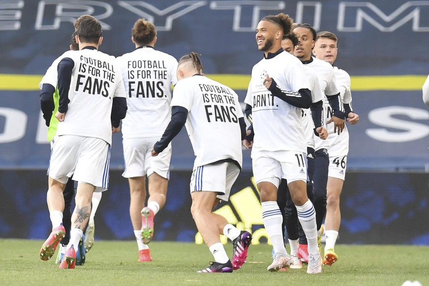 Leeds United players warm up ahead of the English Premier League soccer match between Leeds United and Liverpool at the Elland Road stadium in Leeds, England, Monday, April 19, 2021. (Paul Ellis/Pool  ...