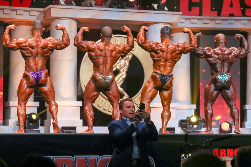 COLUMBUS, OH - MARCH 02: Gaetano Cisternino Jr. (7), David Henry (5), Kamal Elgargni (1) and Charles Dixon (6) compete as Arnold Schwarzenegger takes a snapchat selfie during the Arnold Classic 212 as ...