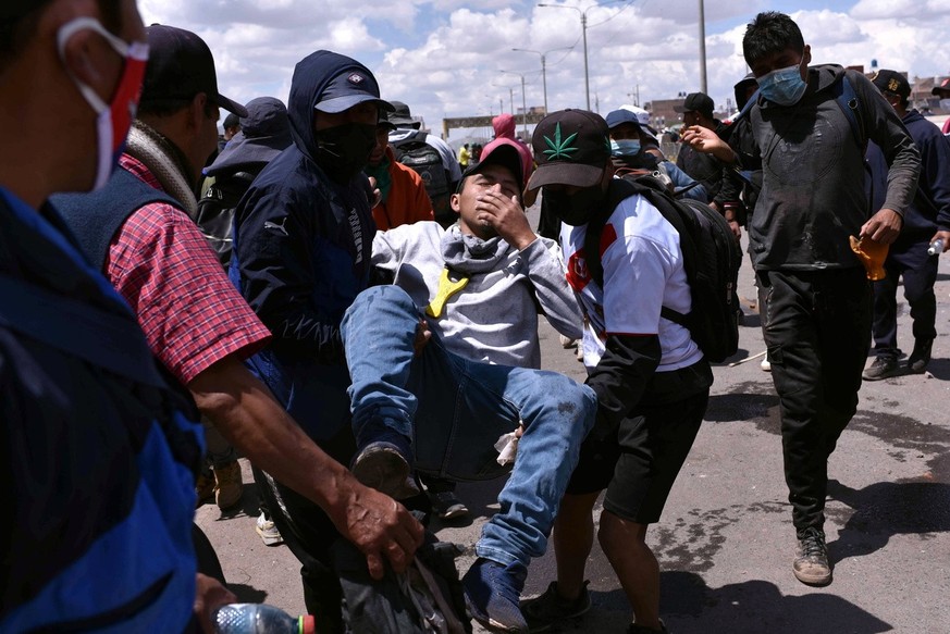 epa10397382 A man injured in clashes between protesters and security forces is taken to be treated, in Juliaca, Peru, 09 January 2023. 12 people died in Juliaca on 09 January, bringing the total to 41 ...