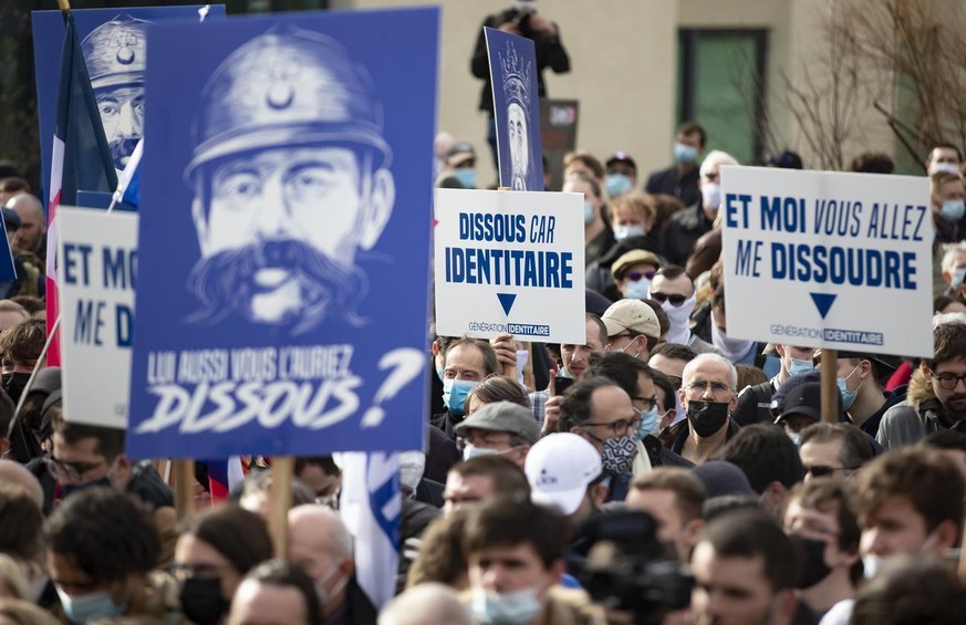 epa09026514 Protesters attend a demonstration by French far-right group Generation Identitaire to protest against a government initiative to dissolve the group, in Paris, France, 20 February 2021. The ...