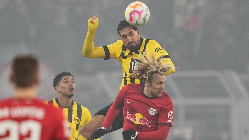 Dortmund&#039;s Emre Can, top, and Leipzig&#039;s Emil Forsberg challenge for the ball during the German Bundesliga soccer match between Borussia Dortmund and RB Leipzig in Dortmund, Germany, Friday,  ...