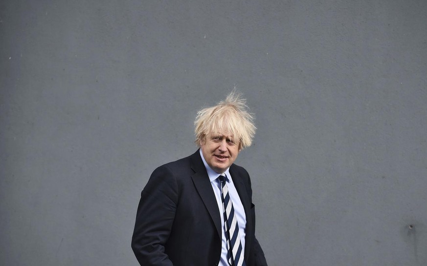 Britain&#039;s Prime Minister Boris Johnson is greeted with an elbow bump by First Minister Arlene Foster during a visit to the Lakeland Forum vaccination centre in Enniskillen, Northern Ireland, Frid ...