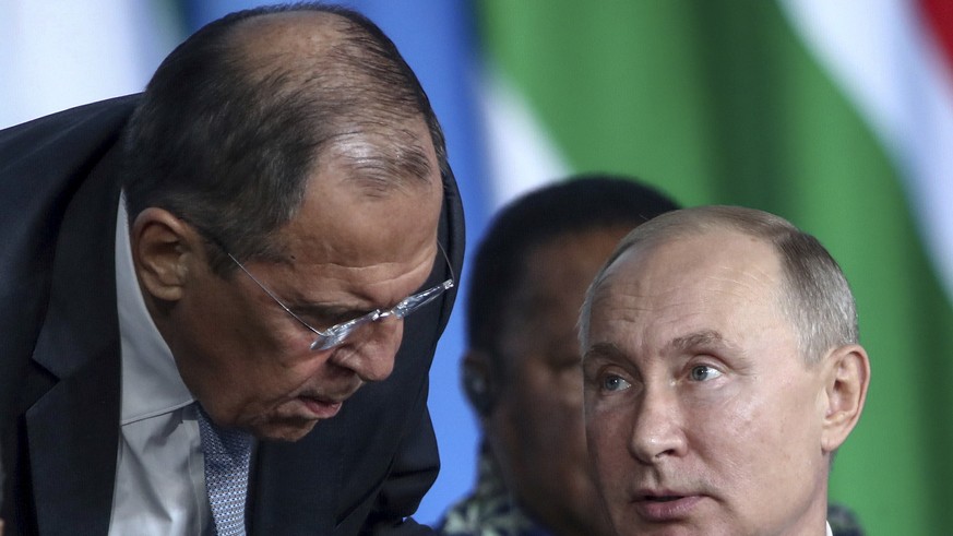 FILE - Russian President Vladimir Putin, right, listens to Russian Foreign Minister Sergey Lavrov, top, as Egyptian President Abdel Fattah el-Sisi sits next during a plenary session at the Russia-Afri ...