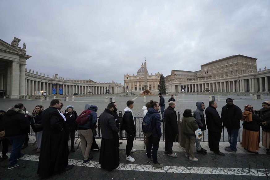 People wait in a line to enter Saint Peter&#039;s Basilica at the Vatican where late Pope Benedict 16 is being laid in state at The Vatican, Monday, Jan. 2, 2023. Benedict XVI, the German theologian w ...