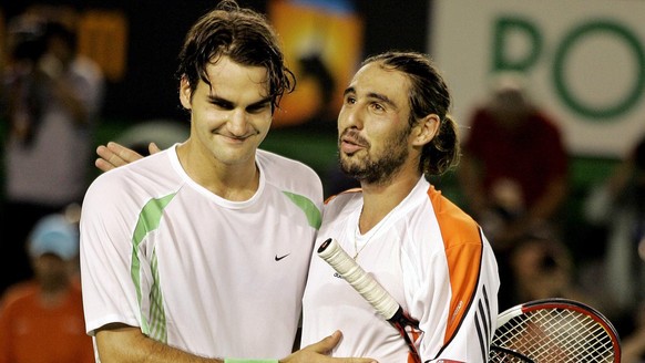 Switzerland's Roger Federer, left, is congratulated by Cypriot Marcos Baghdatis after winning the men's singles final at the Australian Open tennis tournament in Melbourne, Australia, Sunday ...