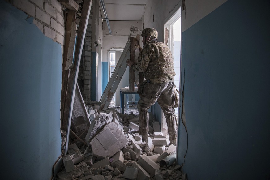 A Ukrainian soldier makes his way amidst rubble during heavy fighting at the front line in Severodonetsk, Luhansk region, Ukraine, Wednesday, June 8, 2022. (AP Photo/Oleksandr Ratushniak)