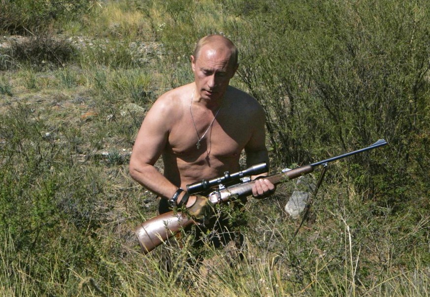 FILE In this Sept. 2010 photo released on Saturday, Oct. 30, 2010, then Russian Prime Minister Vladimir Putin carries a hunting rifle during his trip in Ubsunur Hollow in the Siberian Tyva region (als ...