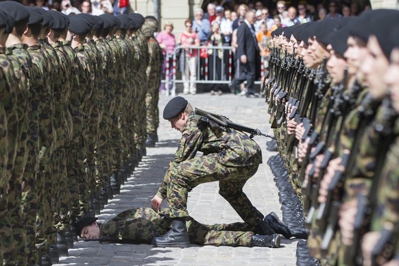 A member of the guard of honour lies on the ground while Francois Hollande, President of France, and Simonetta Sommaruga, Swiss Federal President, inspect the guard of hounour in Bern, Switzerland, We ...
