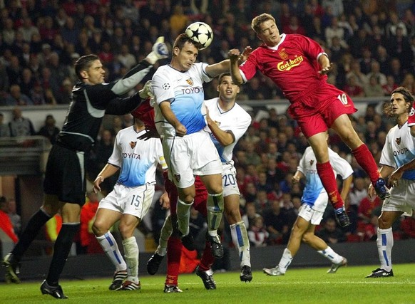 Basel&#039;s goalkeeper Pascal Zuberbuehler punches the ball away from teammate Alexandre Quennoz, centre, and Liverpool&#039;s Michael Owen in the Group B leg of the UEFA Champions League, Wednesday  ...