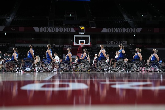 The United States, front, and Canada players line up during the national anthem before a women&#039;s wheelchair basketball quarterfinal game at the Tokyo 2020 Paralympic Games, Tuesday, Aug. 31, 2021 ...