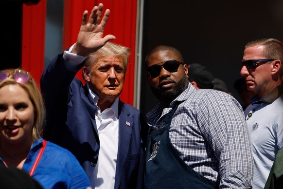 DES MOINES, IOWA - AUGUST 12: Former U.S. President Donald Trump visits the Iowa Pork Producers Tent with Rep. Byron Donalds (R-FL) at the Iowa State Fair on August 12, 2023 in Des Moines, Iowa. Repub ...