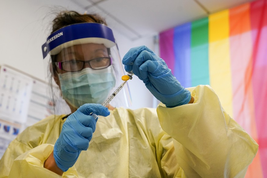 Physician Assistant Susan Eng-Na prepares a string with the monkeypox vaccine before inoculating a patient during a vaccination clinic at the OASIS Wellness Center, Friday, Aug. 19, 2022, in New York. ...