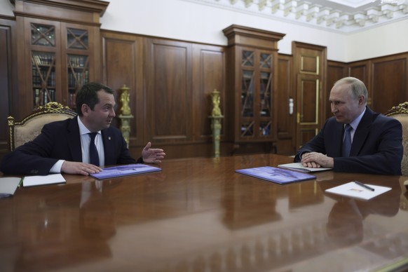 Russian President Vladimir Putin, right, speaks with Murmansk region Governor Andrei Chibis, left, during their meeting at the Kremlin in Moscow, Russia, on Tuesday, Aug. 6, 2024. (Gavriil Grigorov, S ...