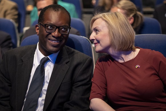 epa10219886 British Prime Minister Liz Truss (R) and Britain&#039;s Chancellor of the Exchequer Kwasi Kwarteng (L) chat at the opening session of Conservative Party Conference in Birmingham, Britain,  ...