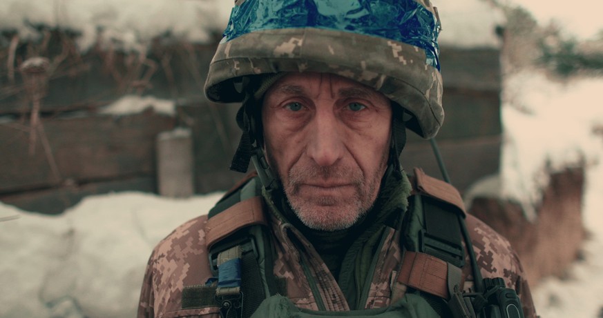 Close-up of an elderly Ukrainian soldier in military uniform and helmet. A Ukrainian soldier in a snowy trench. Model Released Property Released xkwx war army battle military soldier conflict invasion ...