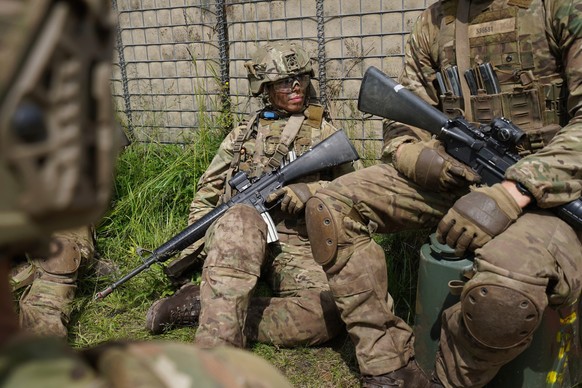 A female conscript sits with members of her unit during final exercises at a training area close to Royal Danish Army&#039;s barracks in Hovelte, 25 kilometres north of Copenhagen, Denmark, Wednesday, ...