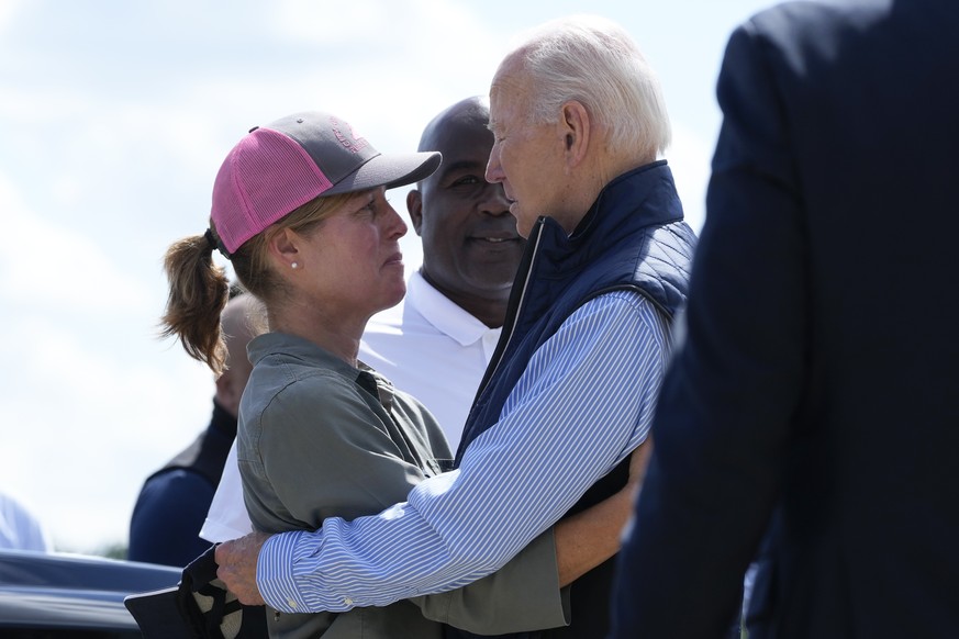 President Joe Biden talks with Asheville Mayor Esther Manheimer, as he arrives at Greenville-Spartanburg International Airport in Greer, S.C., Wednesday, Oct. 2, 2024, to survey damage from Hurricane  ...