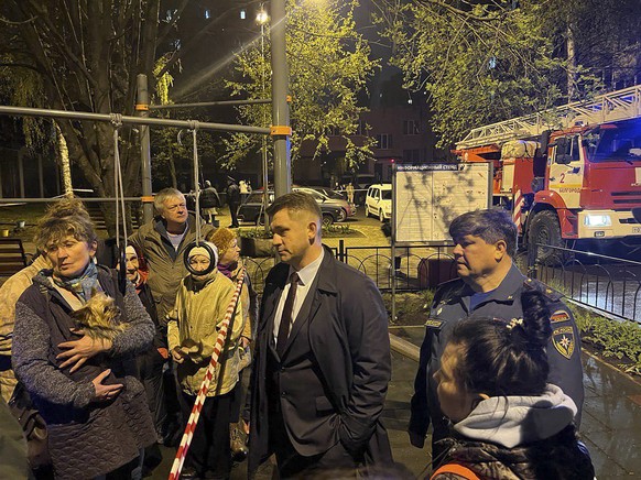 epa10583550 A handout photo made available by the Governor of the Belgorod Region Vyacheslav GladkovÄôs telegram channel shows locals standing near the blast site in downtown Belgorod, Russia, 20 Apr ...