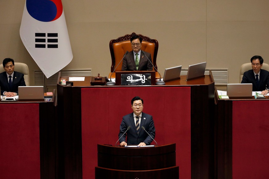 epa11776022 Opposition Democratic Party Floor leader Park Chan-dae (C bottom), speaks during the plenary session for the impeachment vote of President Yoon Suk Yeol at the National Assembly in Seoul,  ...