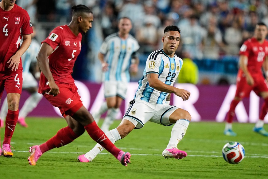 Switzerland's Manuel Akanji (5) challenges for the ball with Argentina's Lautaro Martinez (22) during the World Cup quarterfinal soccer match in Kansas City, Mo., Saturday, July 11, 2026. (A ...
