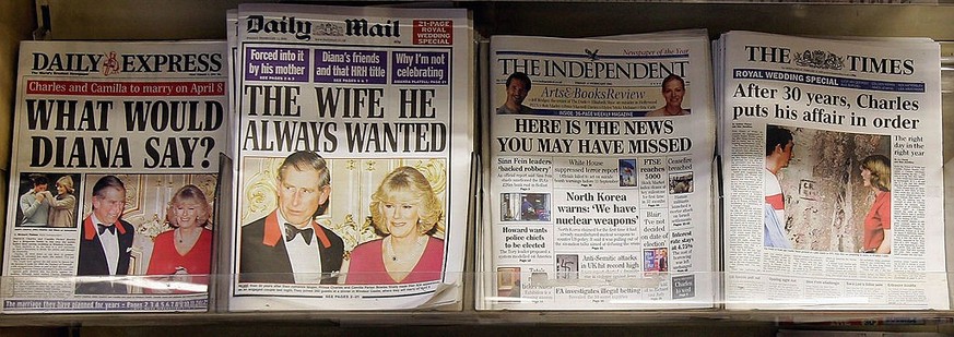LONDON - FEBRUARY 11: Photographs of Prince Charles and Camilla Parker Bowles dominate the front pages of British daily newspapers as they sit on display in a newsagents on February 11, 2005 in London ...