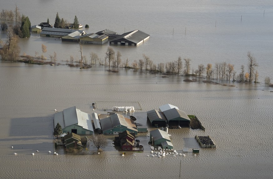 A farm is surrounded by floodwaters in Abbotsford, British Columbia, Tuesday, Nov. 16, 2021. (Jonathan Hayward/The Canadian Press via AP)
