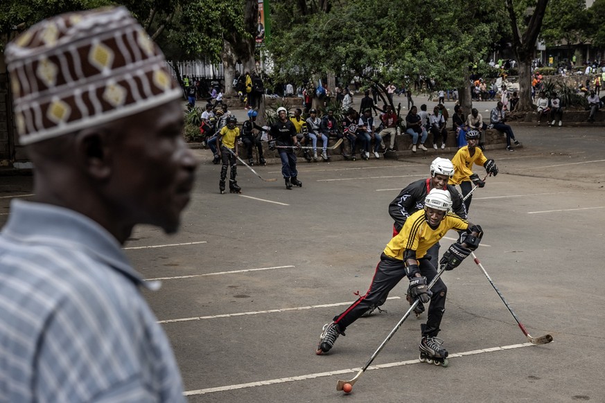 Players practice inline roller hockey, some of them from the Kenyan Ice Hockey National Team, as they teach junior players the game as an initiation to the sport for those who cannot afford ice rink t ...