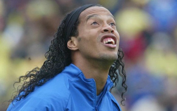 Brazil&#039;s national soccer player Ronaldinho eyes a ball during a training session at Thermoplan arena in Weggis, central Switzerland, Wednesday, May 31, 2006. Brazil will play against Australia, C ...