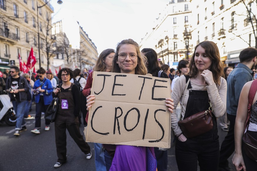 epa11949898 A demonstrator carries a banner with the message 'I believe in you' during a rally marking International Women's Day in Paris, France, 08 March 2025. International Women ...