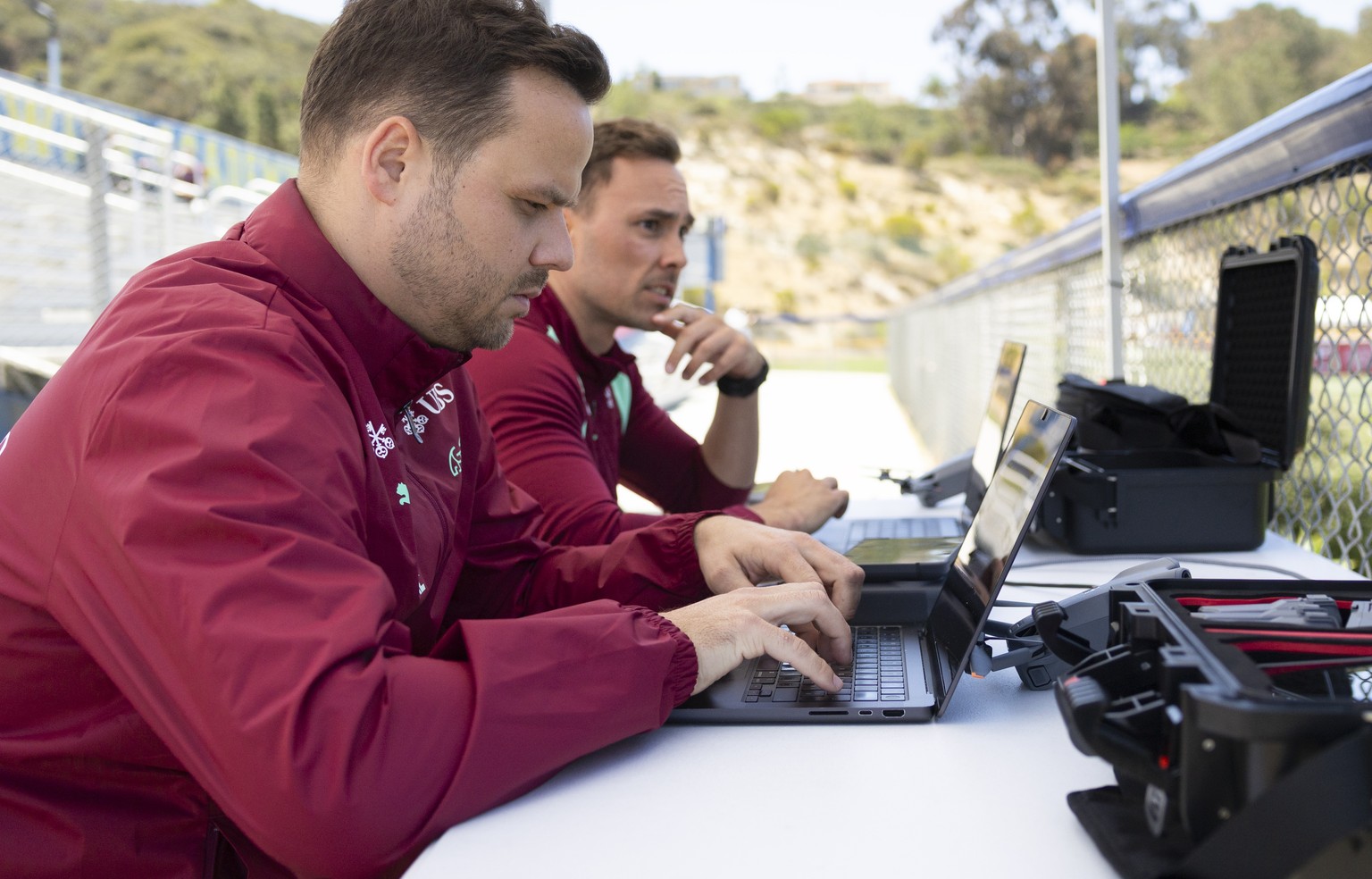 Switzerland's team video and data analysts Kevin Ehmes, front, and Julian Lauer, back, observe a training session of the Swiss national soccer team at the SDJA in San Diego, California, USA, Tues ...