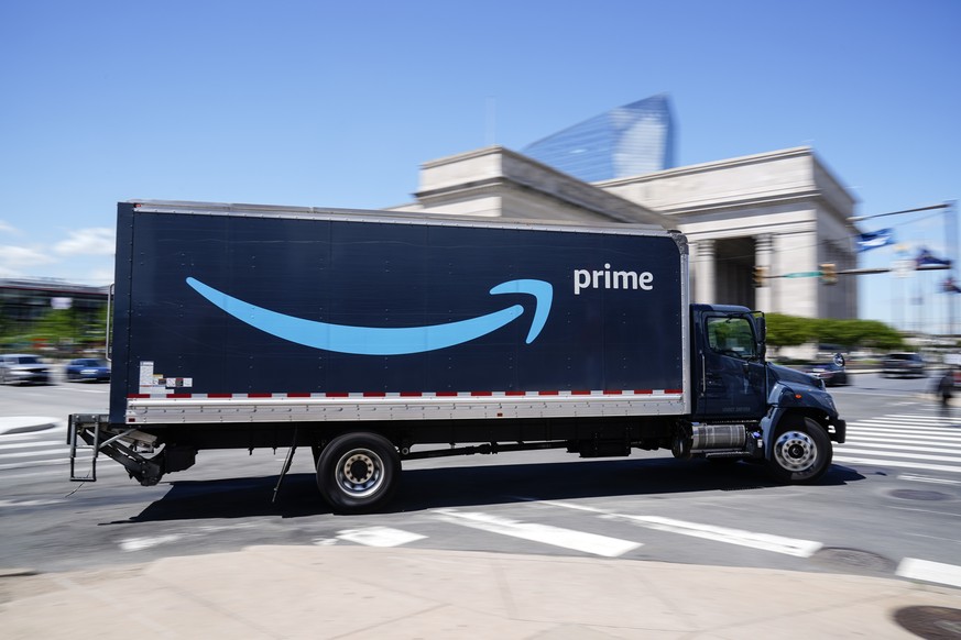 FILE - An Amazon truck drives in in Philadelphia, Friday, April 30, 2021. Amazon wants to hire 125,000 delivery and warehouse workers and said Tuesday, Sept. 14, 2021 that it is paying new hires an av ...