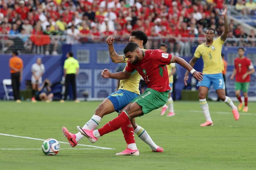 Morocco's Ismael Saibari (11) takes a shot on goal against Brazil's Marquinhos (4) in the second half during the World Cup Group C soccer match between Brazil and Morocco in East Rutherford, ...