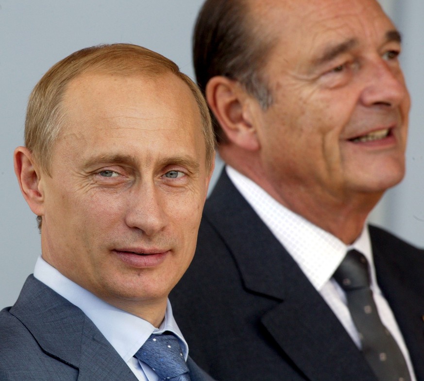 Russian President Vladimir Putin, left, and French President Jacques Chirac, right, pose for the media after a meeting at the Hotel Royal in Evian, France, Monday June 2, 2003. G8 leaders met Monday f ...