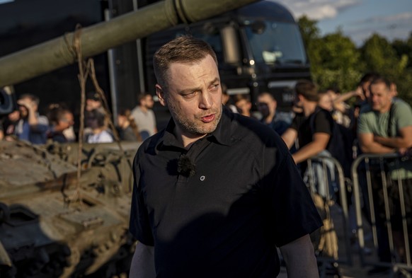 epa10065653 Ukrainian Interrnal Affairs Minister Denys Monastyrsky stands next to destroyed Russian T-90 tank during the opening of an exhibition of Russian military equipment that was destroyed in fi ...