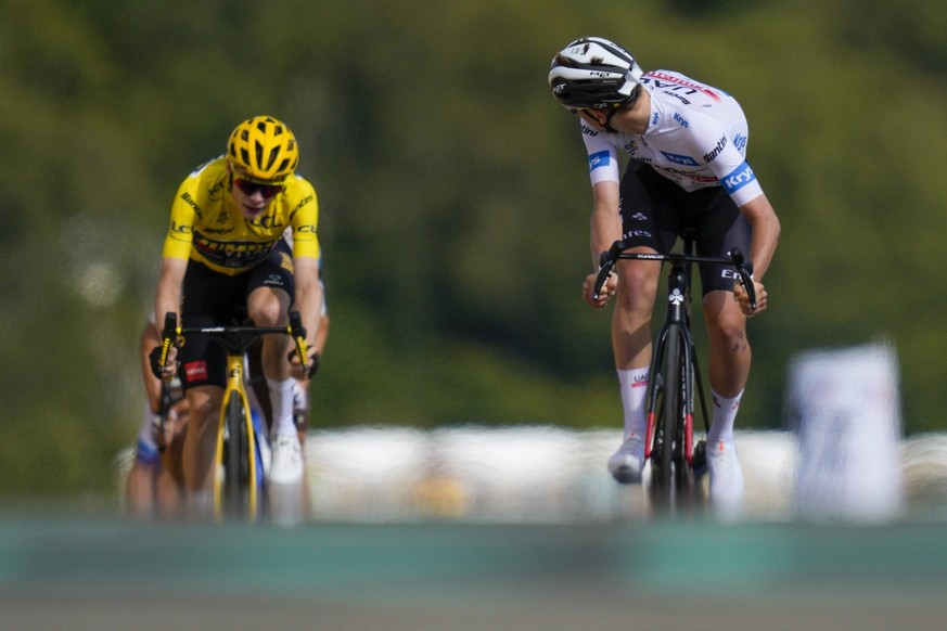 Slovenia&#039;s Tadej Pogacar, wearing the best young rider&#039;s white jersey, looks back to see the lead he has in the final sprint over Denmark&#039;s Jonas Vingegaard, wearing the overall leader& ...