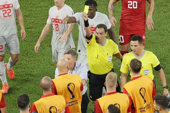 epa10345253 Argentinian referee Fernando Rapallini show the yellow card to a player from the Serbian bench during the FIFA World Cup 2022 group G soccer match between Serbia and Switzerland at Stadium ...