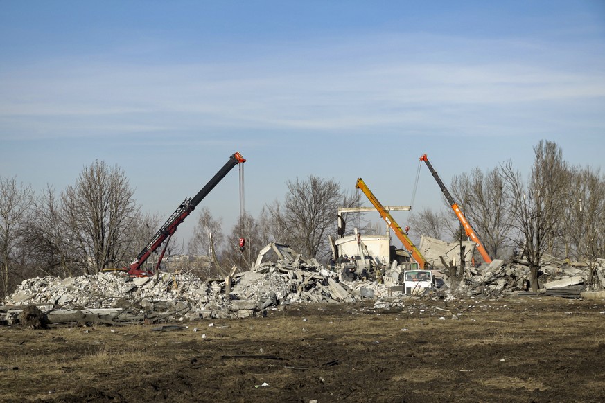 Workers clean rubbles after Ukrainian rocket strike in Makiivka, in Russian-controlled Donetsk region, eastern Ukraine, Tuesday, Jan. 3, 2023. Russia&#039;s defense ministry says 63 of its soldiers ha ...