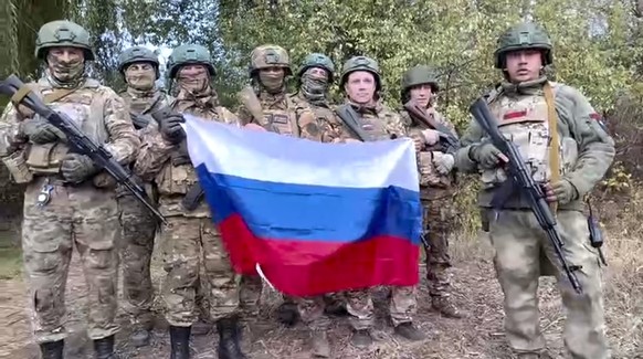 In this image made from video released by the Russian Defense Ministry on Monday, Nov. 4, 2024, Russian soldiers record video congratulations at an undisclosed location in Ukraine. (Russian Defense Mi ...
