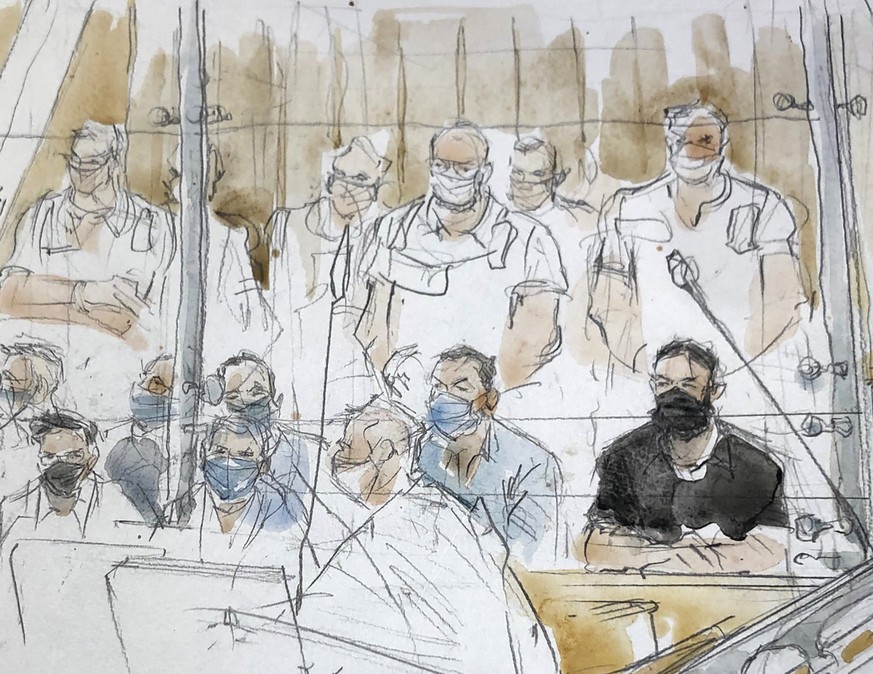 This sketch shows key defendant Salah Abdeslam, in black at right, in the special courtroom built for the 2015 attacks trial, Wednesday, Sept. 8, 2021 in Paris. The trial of 20 men accused in the Isla ...