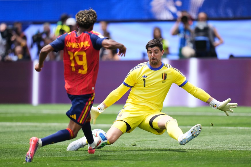 Belgium goalkeeper Thibaut Courtois (1) saves a shot by Spain's Lamine Yamal (19) during the World Cup quarterfinal soccer match between Spain and Belgium in Inglewood, Calif., near Los Angeles,  ...